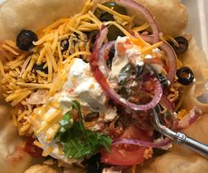 A Taco Salad with the works, served in a taco shell. A Taco Tuesday favorite.